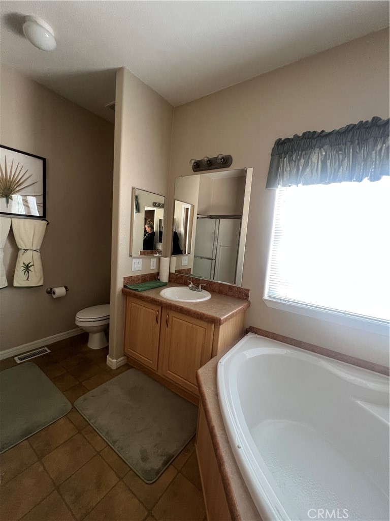 1189 Marina Drive Needles, CA 92363 - Photo 22 of 26 a bathroom with a sink toilet and shower