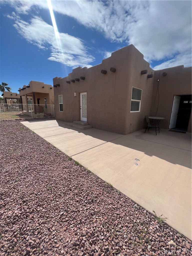 1189 Marina Drive Needles, CA 92363 - Photo 25 of 26 a pathway of a house with a yard