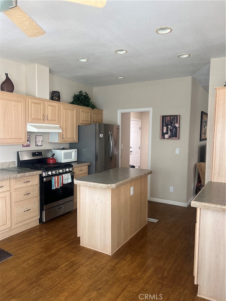 1189 Marina Drive Needles, CA 92363 - Photo 9 of 26 a kitchen with granite countertop a refrigerator stove top oven and sink
