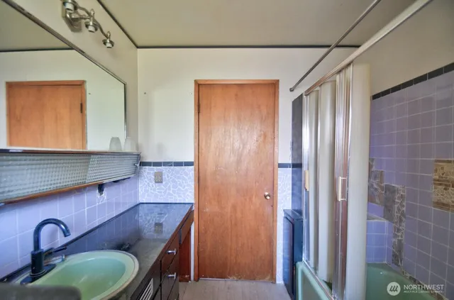 a bathroom with a granite countertop sink and a mirror