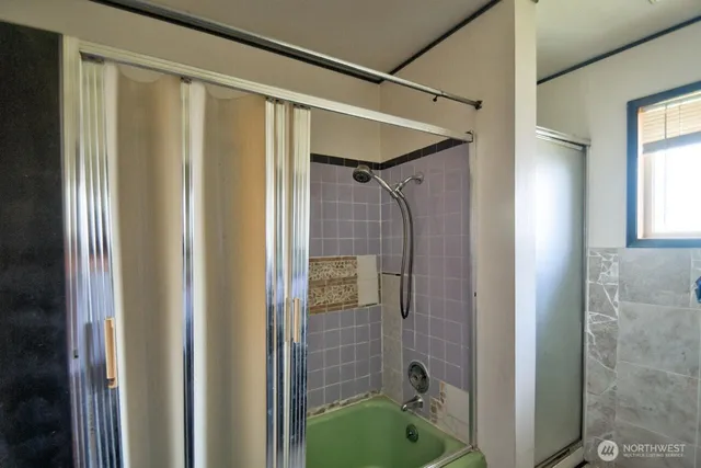 a bathroom with a shower and a tub