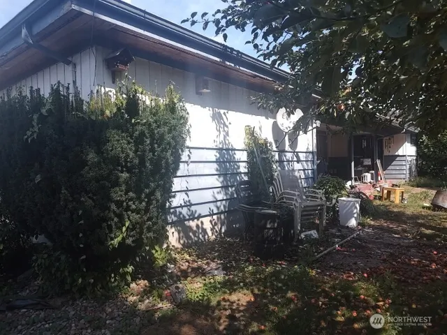 a view of a house with swimming pool and sitting area
