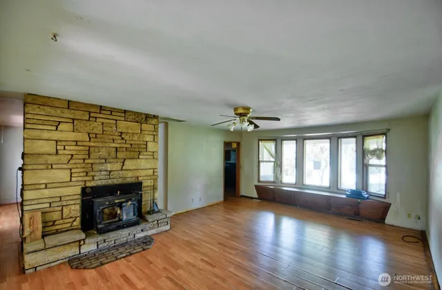 a living room with hardwood floor and a fireplace