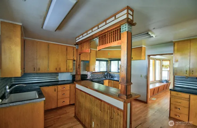 a kitchen with granite countertop a sink and a refrigerator