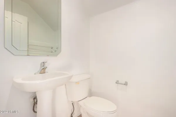 a bathroom with a sink a toilet and mirror