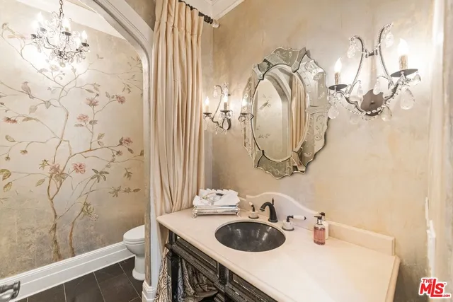 a bathroom with a sink vanity granite and a mirror