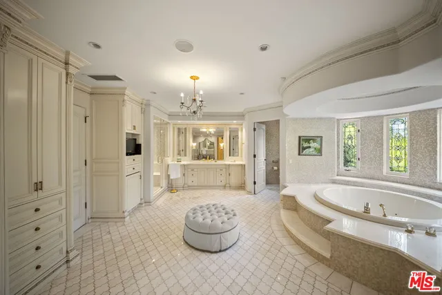 a spacious bathroom with a tub shower and sink