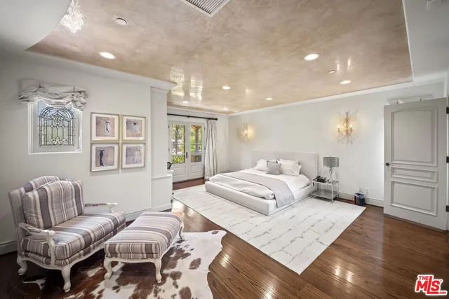 a bedroom with furniture and wooden floor