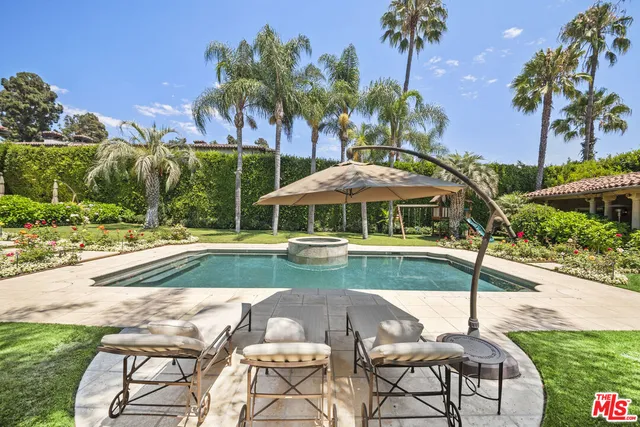 a view of a house with swimming pool and sitting area