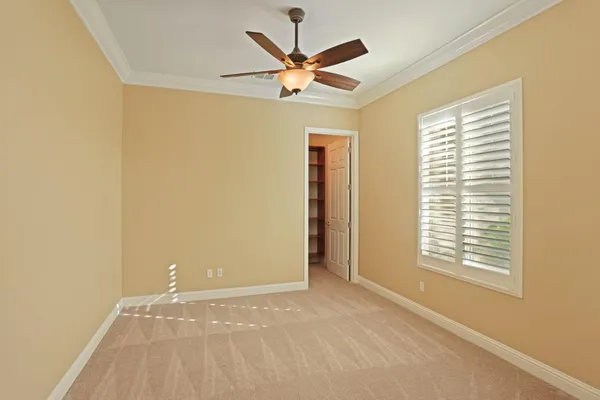 a view of an empty room with a fireplace and a window