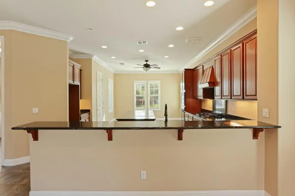 a kitchen with stainless steel appliances granite countertop a sink stove and cabinets