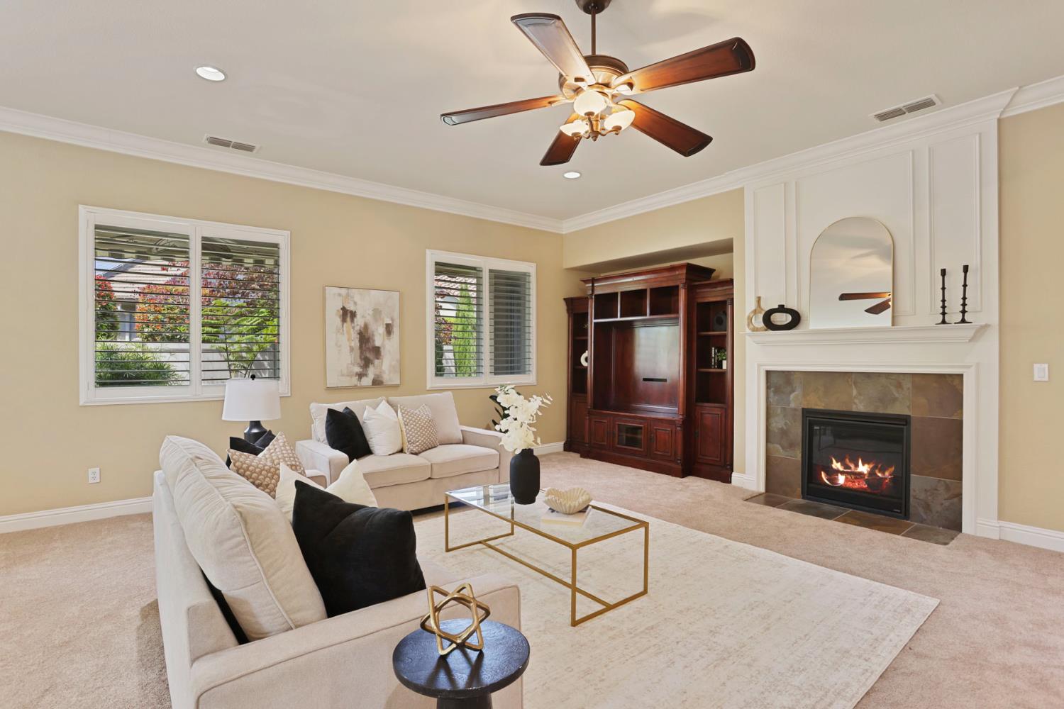 2439 Appleleaf Lane Manteca, CA 95336 - Photo 18 of 73 a living room with furniture a fireplace and a large window