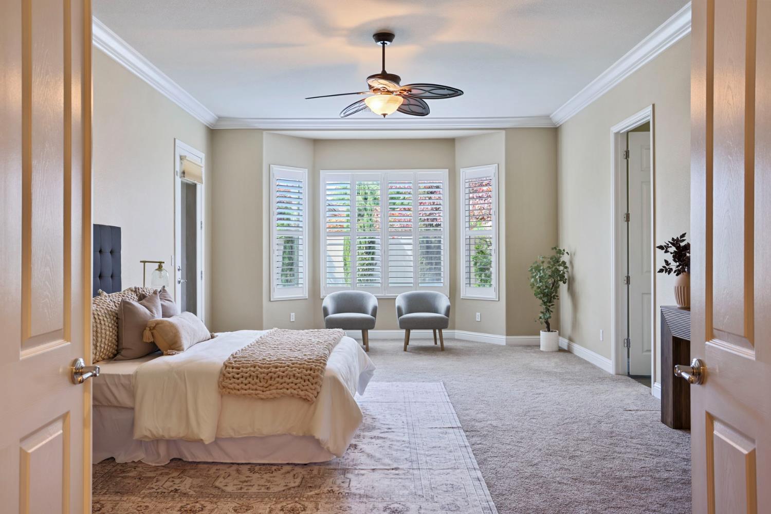2439 Appleleaf Lane Manteca, CA 95336 - Photo 4 of 73 a spacious bedroom with a bed and a chandelier