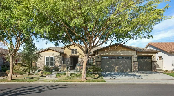 a front view of a house with garden and patio