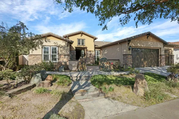 a front view of a house with plants