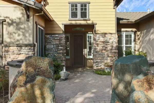 a backyard of a house with barbeque oven and outdoor seating