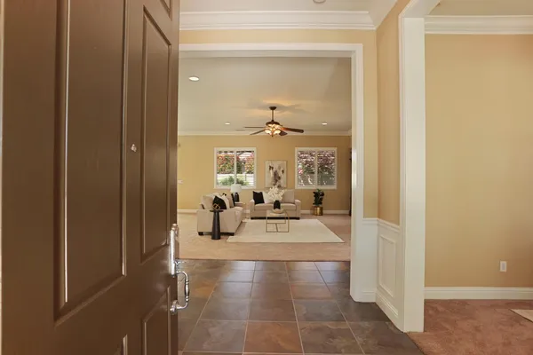 a living room with furniture fireplace and large windows