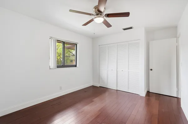 a view of empty room with wooden floor