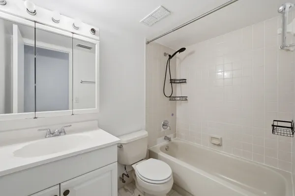 a bathroom with a sink toilet vanity and shower