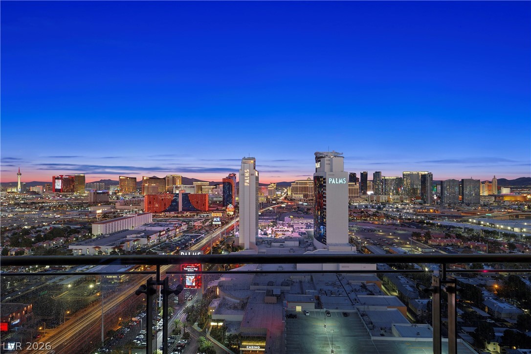 4381 West Flamingo Road, Unit 10306 Las Vegas, NV 89103 - Photo 25 of 26 An expansive cityscape view from a high-rise balcony at twilight.