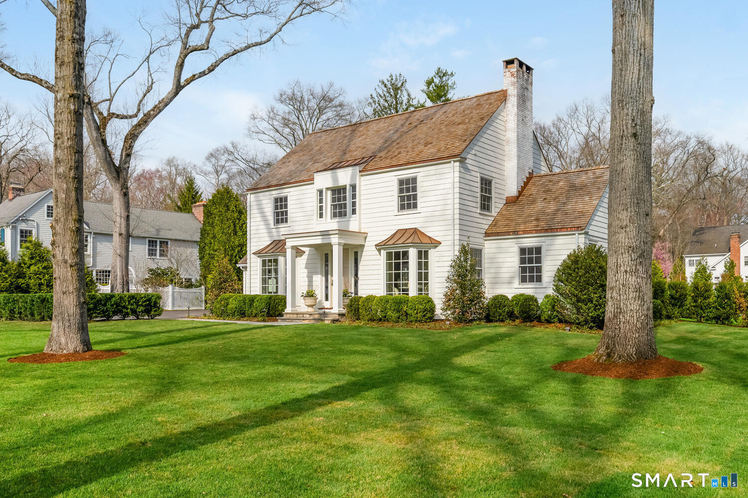 32 Birch Road Darien, CT 06820 - Photo 2 of 40 a view of a white house with a big yard and large trees