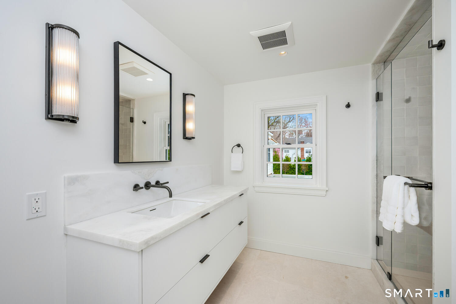 32 Birch Road Darien, CT 06820 - Photo 26 of 40 a bathroom with a double vanity sink a mirror and a shower
