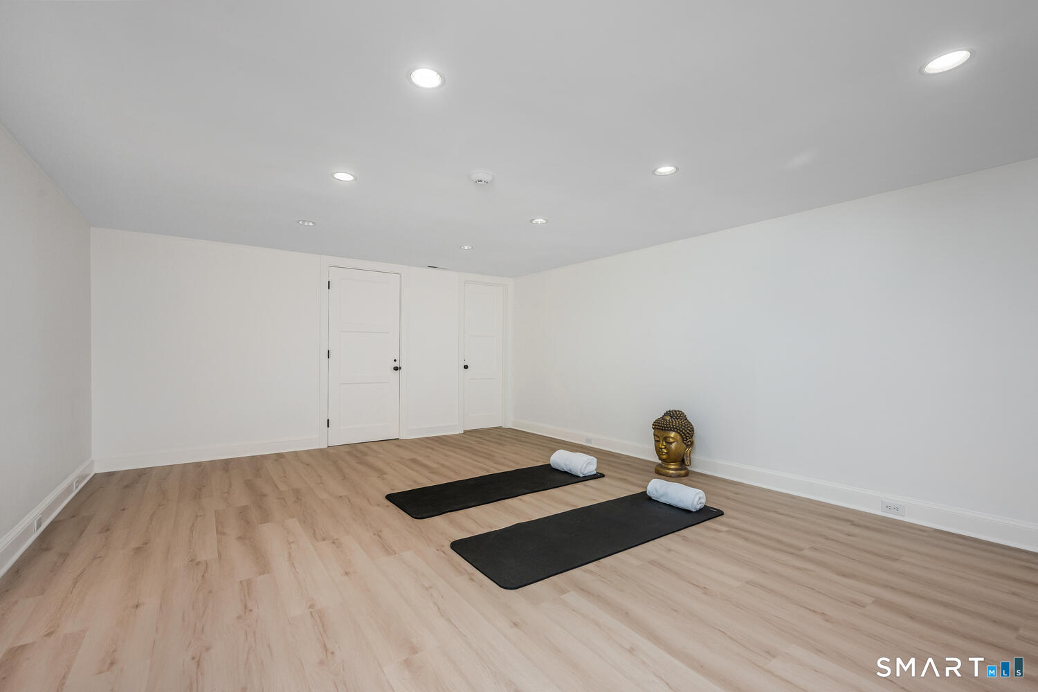 32 Birch Road Darien, CT 06820 - Photo 31 of 40 a bedroom with a bed and a wooden floor