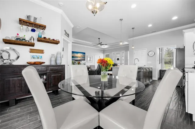 a view of a dining room with furniture and wooden floor