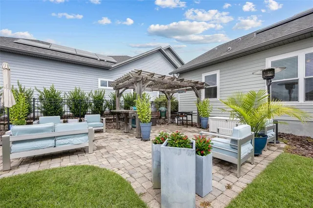 a view of a patio with couches table and chairs and potted plants