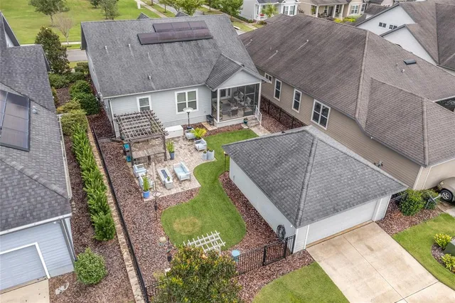 an aerial view of multiple houses with a yard