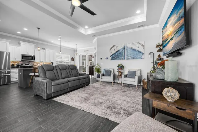 a living room with furniture and a dining table