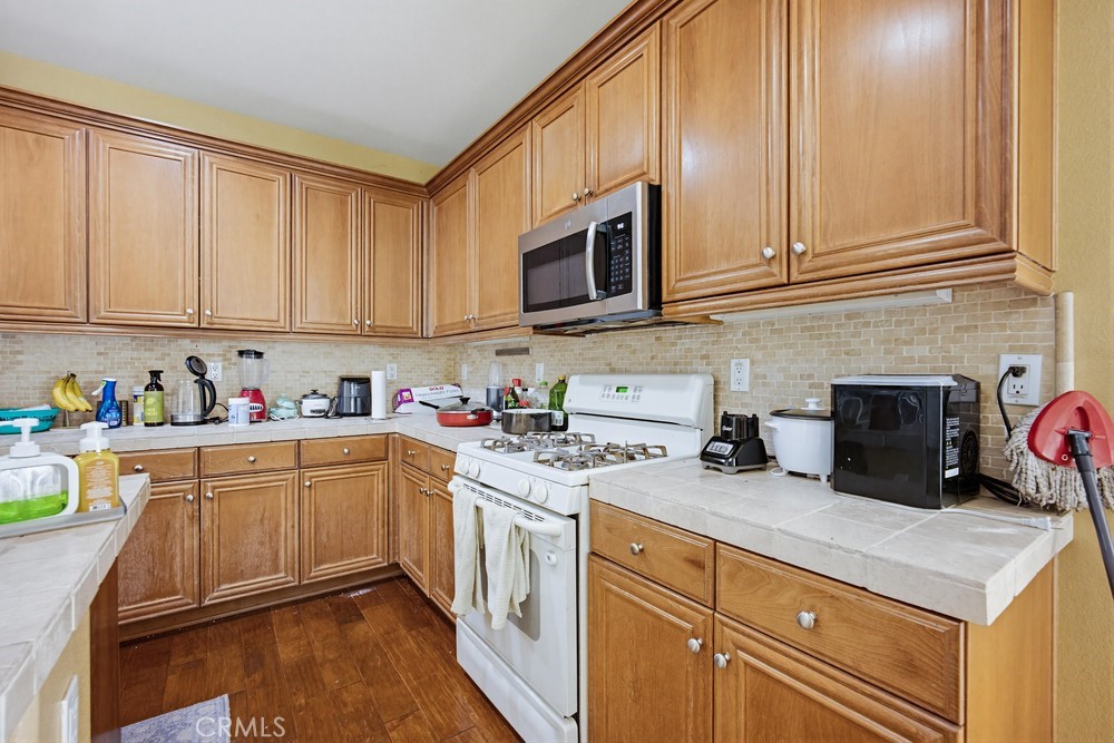 1747 Palermo Drive Riverside, CA 92507 - Photo 10 of 30 a kitchen with stainless steel appliances granite countertop a stove a sink and white cabinets
