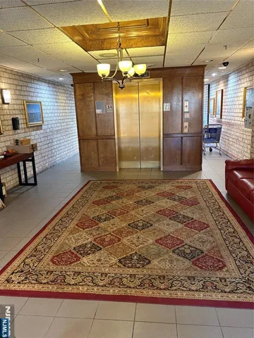 a view of a hallway with chandelier