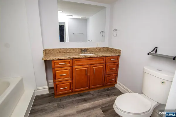 a bath room with a sink and a bath tub