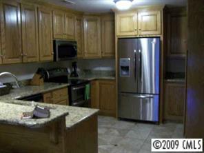 2079 Daytime Road Lancaster, SC 29720 - Photo 3 of 8 a kitchen with a sink and refrigerator