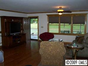 2079 Daytime Road Lancaster, SC 29720 - Photo 5 of 8 a living room with furniture a flat screen tv and floor to ceiling window
