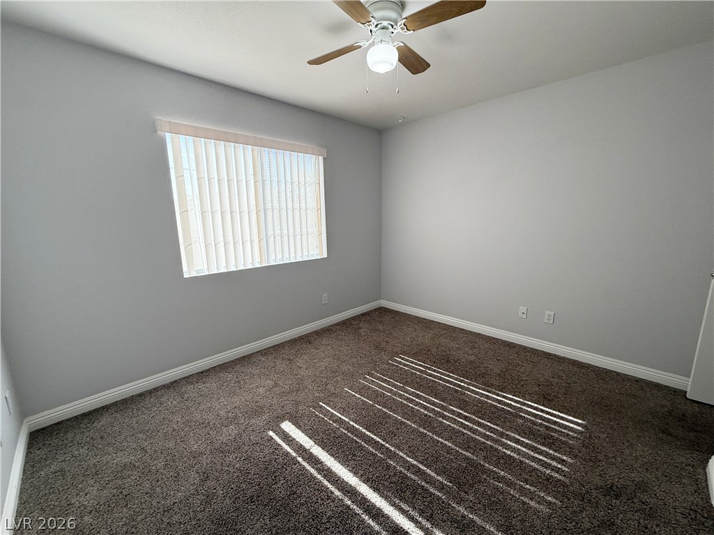 2185 Polynesia Circle Henderson, NV 89074 - Photo 23 of 37 A well-lit bedroom features plush carpeting and a ceiling fan for comfort.