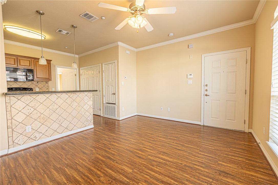 1198 Jones-Butler Road, Unit 2007 College Station, TX 77840 - Photo 2 of 10 a view of an empty room with wooden floor