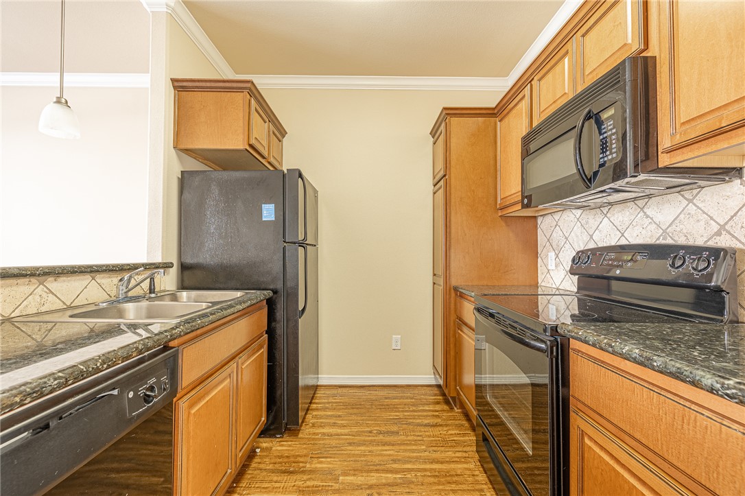 1198 Jones-Butler Road, Unit 2007 College Station, TX 77840 - Photo 3 of 10 a kitchen with stainless steel appliances granite countertop a sink and a stove
