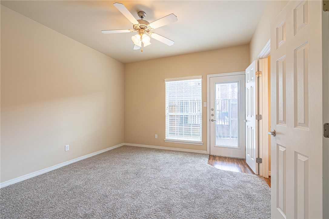 1198 Jones-Butler Road, Unit 2007 College Station, TX 77840 - Photo 5 of 10 an empty room with windows and ceiling fan