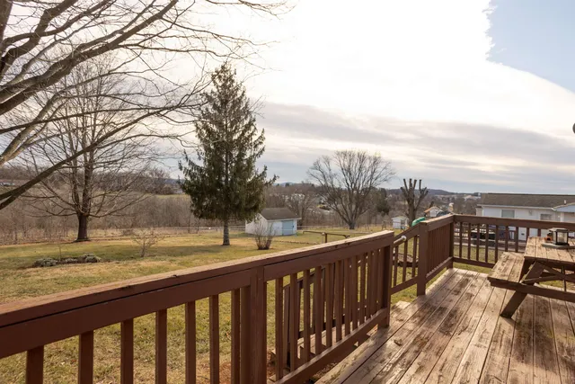 a view of roof deck with wooden fence and floor