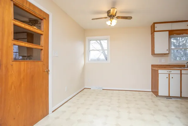 an empty room with windows and closet