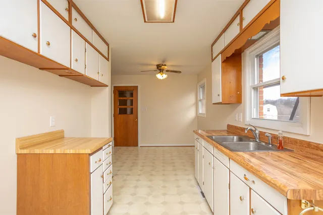 a kitchen with a sink and a refrigerator