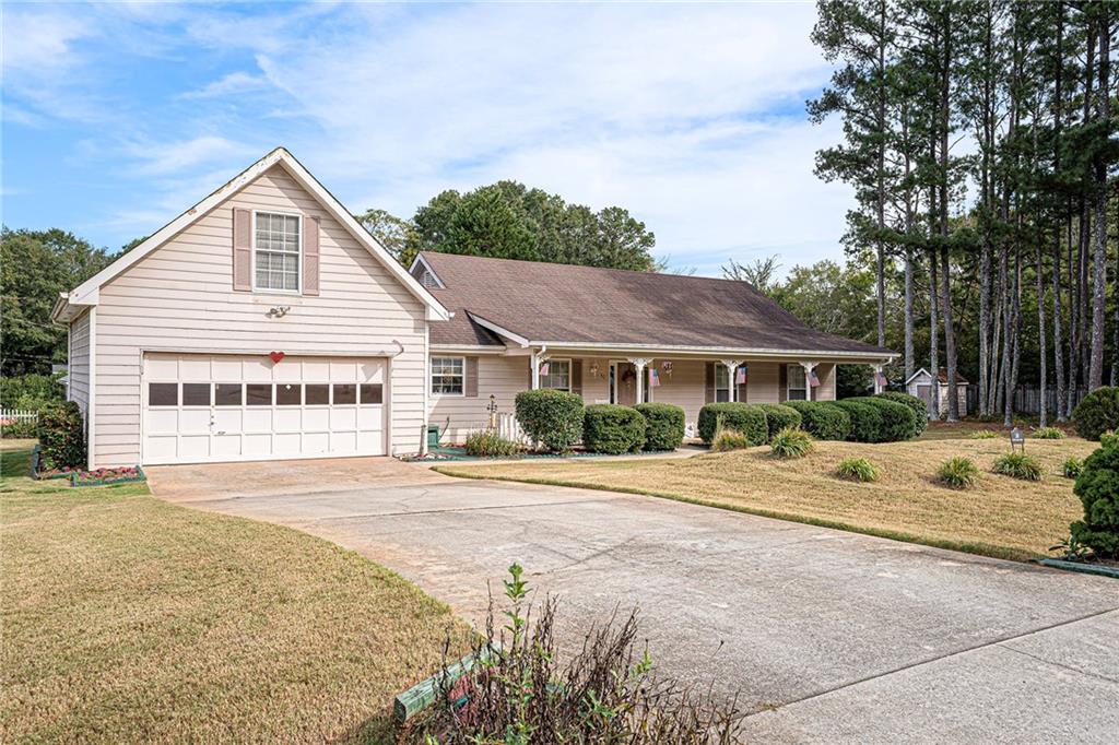 30 Spring Valley Drive Covington, GA 30016 - Photo 1 of 28 a view of a house with a yard and potted plants