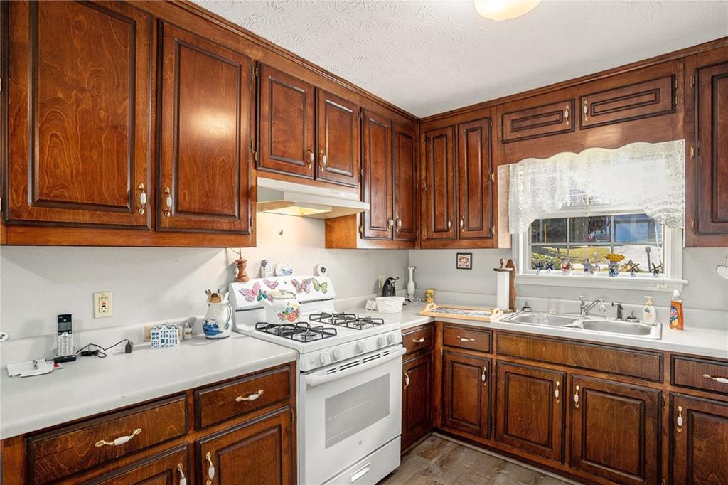 30 Spring Valley Drive Covington, GA 30016 - Photo 12 of 28 a kitchen with stainless steel appliances granite countertop a sink stove and cabinets