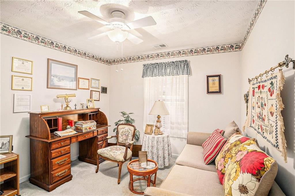 30 Spring Valley Drive Covington, GA 30016 - Photo 14 of 28 a living room with furniture and a chandelier