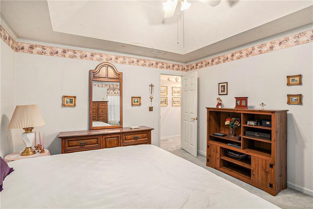 30 Spring Valley Drive Covington, GA 30016 - Photo 16 of 28 a bedroom with a bed and a chandelier