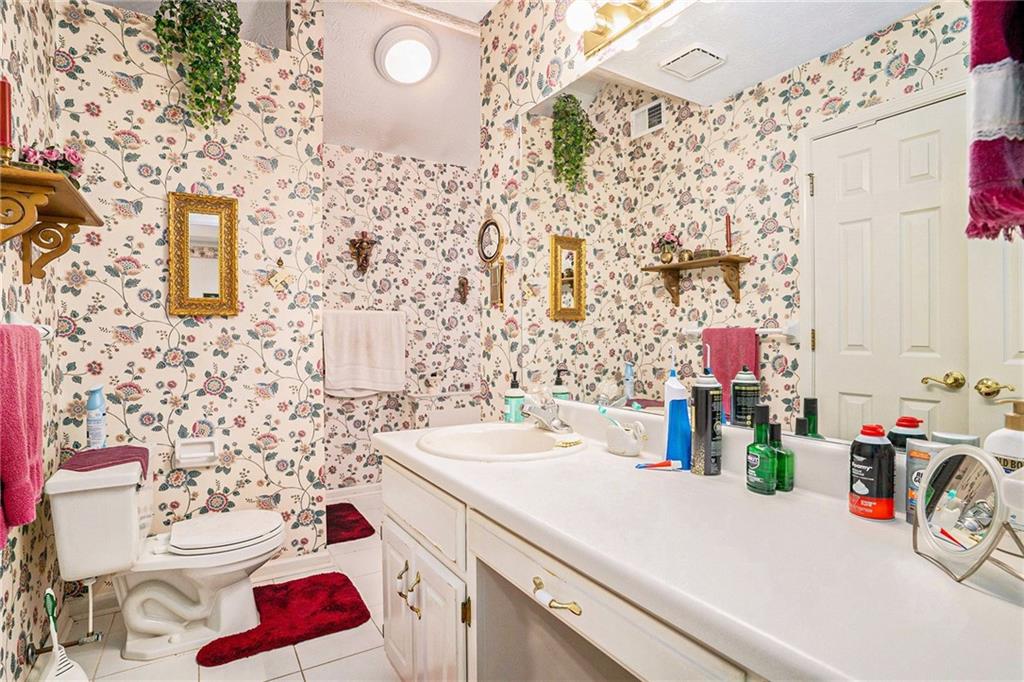 30 Spring Valley Drive Covington, GA 30016 - Photo 18 of 28 a bathroom with a sink vanity mirror and toilet