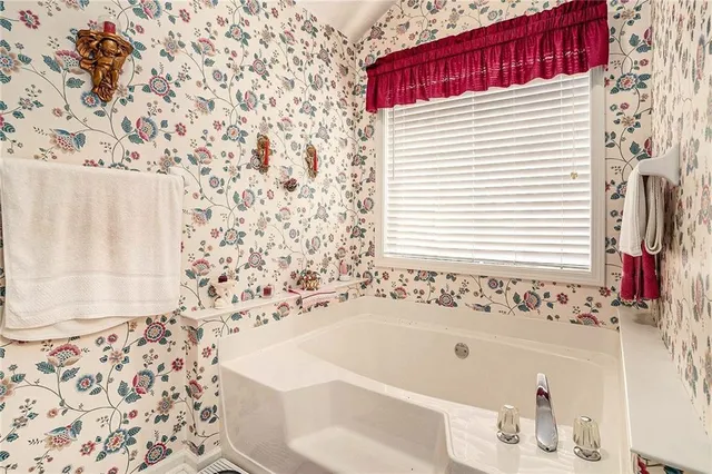 a bedroom with bed and a window