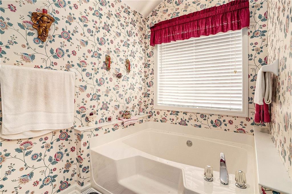 30 Spring Valley Drive Covington, GA 30016 - Photo 19 of 28 a bathroom with a bathtub and shower